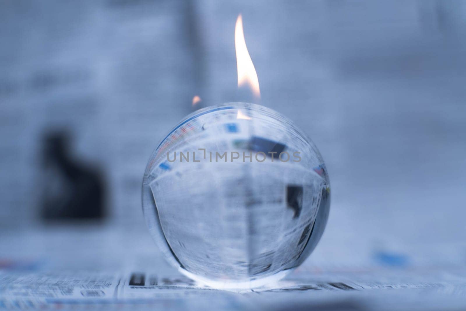 Glass globe on fire. Planet Earth Burning. Global Warming and Climate Change Concept. by TEERASAK