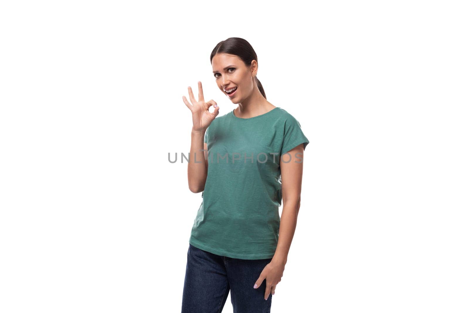 young confident slim woman dressed in a green basic t-shirt with print mockup. corporate clothing concept.