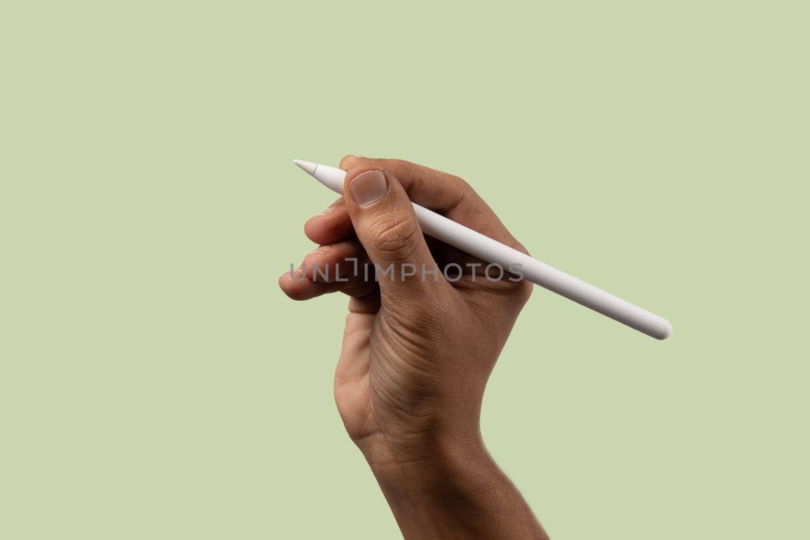 male hand holding an smart pencil isolated on light green. High quality photo