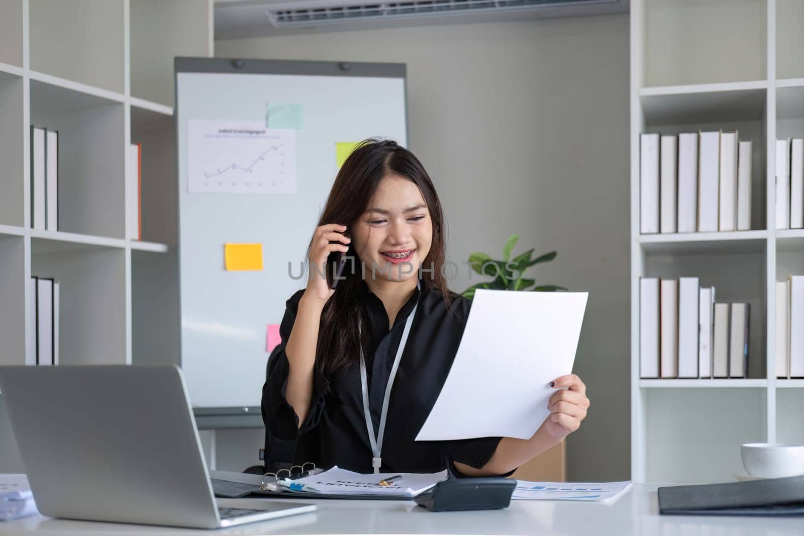 Happy asian business woman have the joy of talking on the smartphone, tablet and laptop on the modern office.