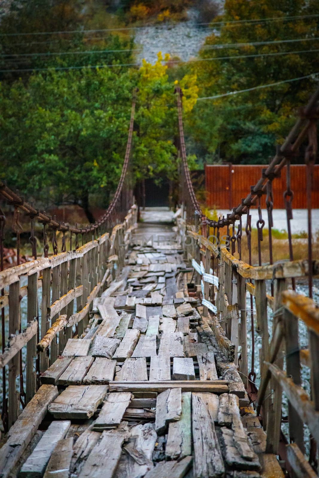 A secluded old wooden bridge that crosses a picturesque river