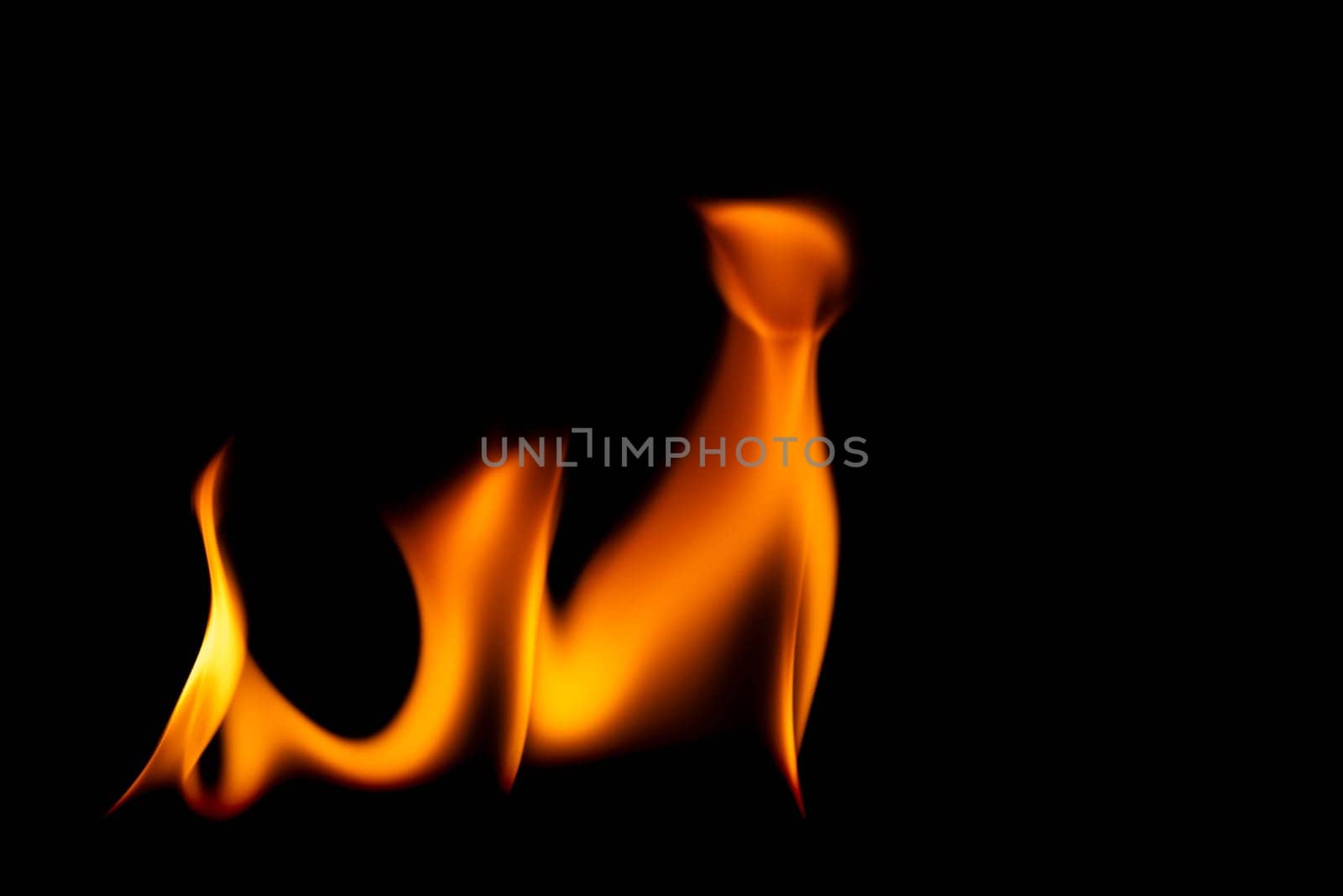 Hot flames on a black background. Beautiful flame of fire in the dark. Abstract of burning flames and smoke. by TEERASAK