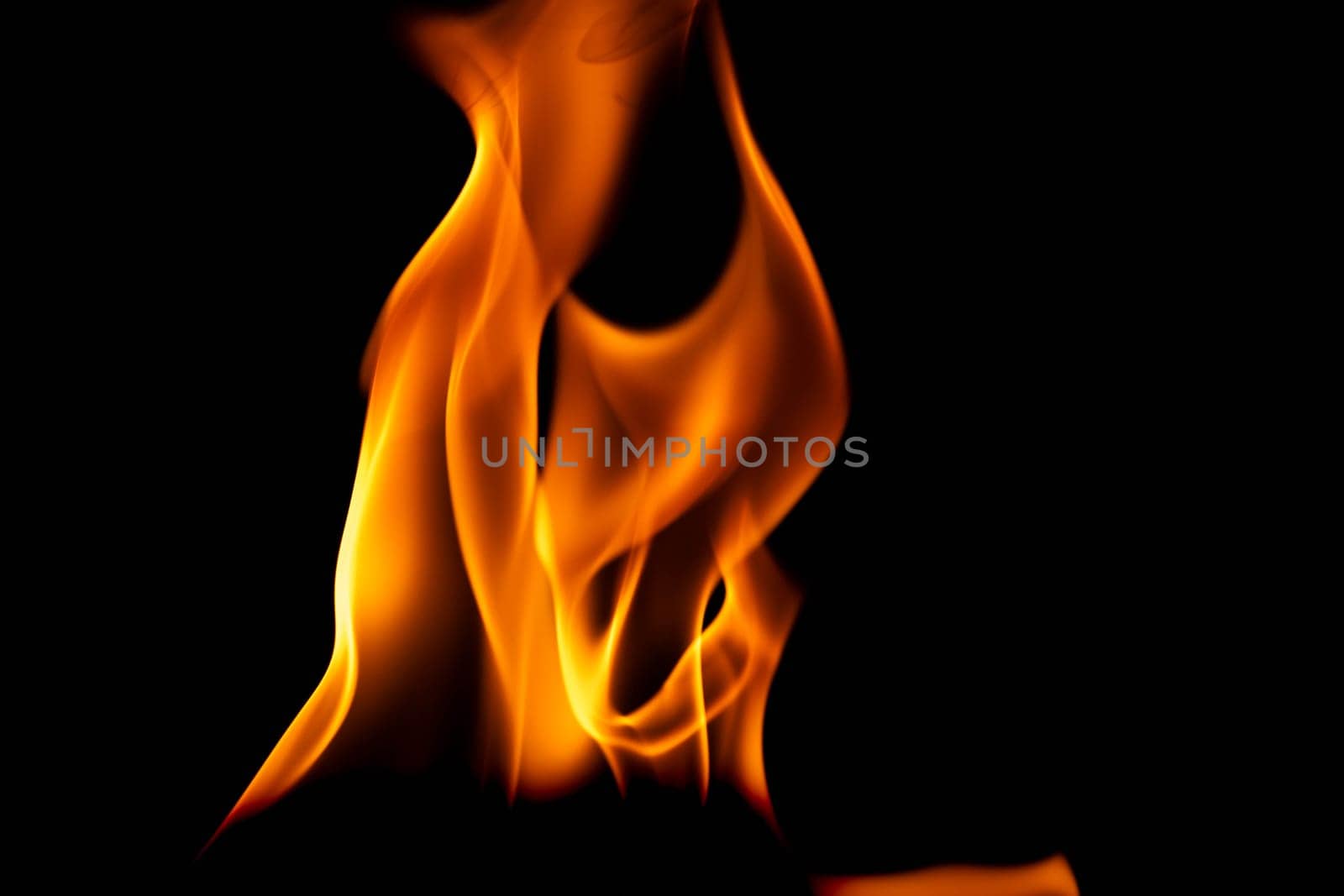 Hot flames on a black background. Beautiful flame of fire in the dark. Abstract of burning flames and smoke.