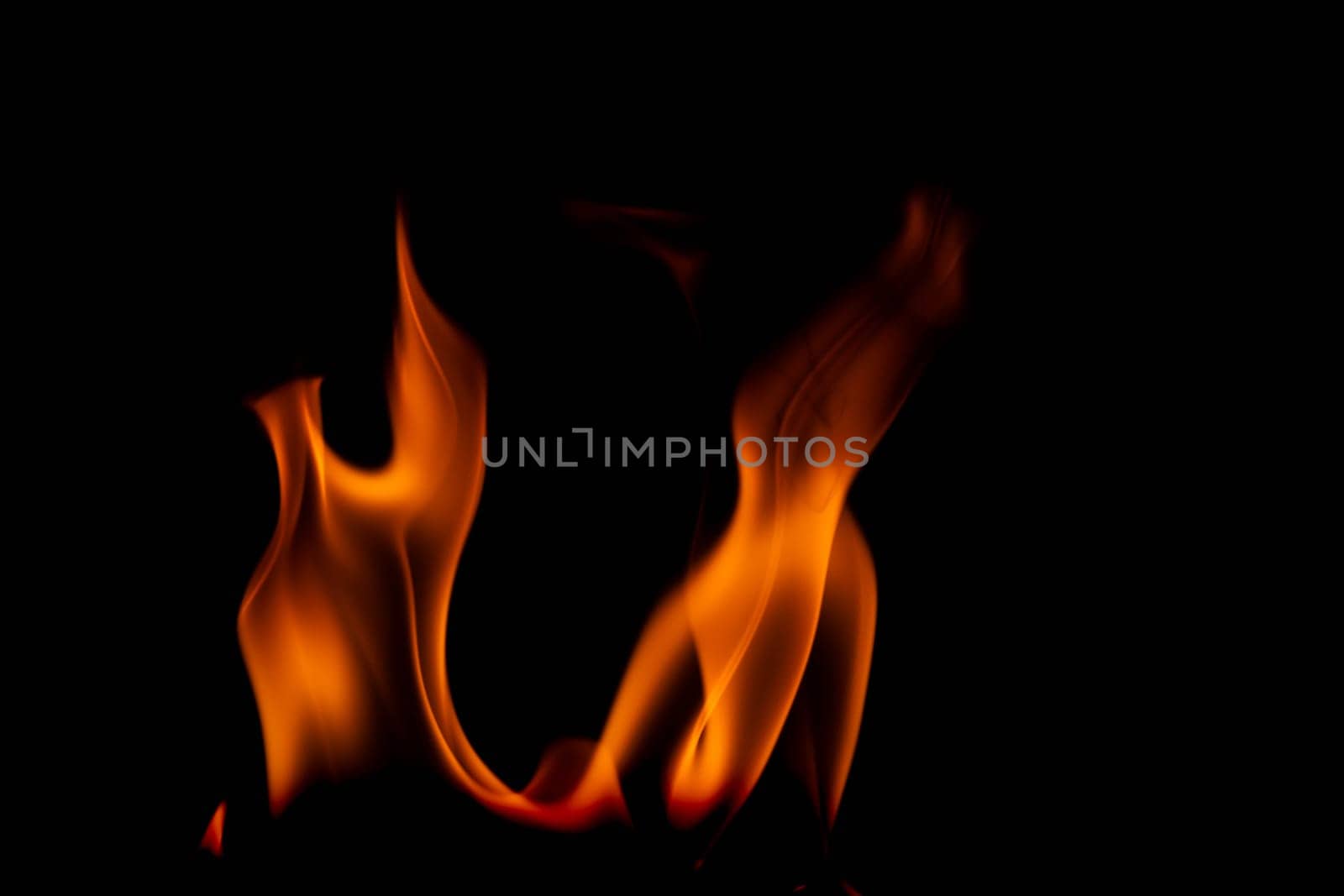 Hot flames on a black background. Beautiful flame of fire in the dark. Abstract of burning flames and smoke.