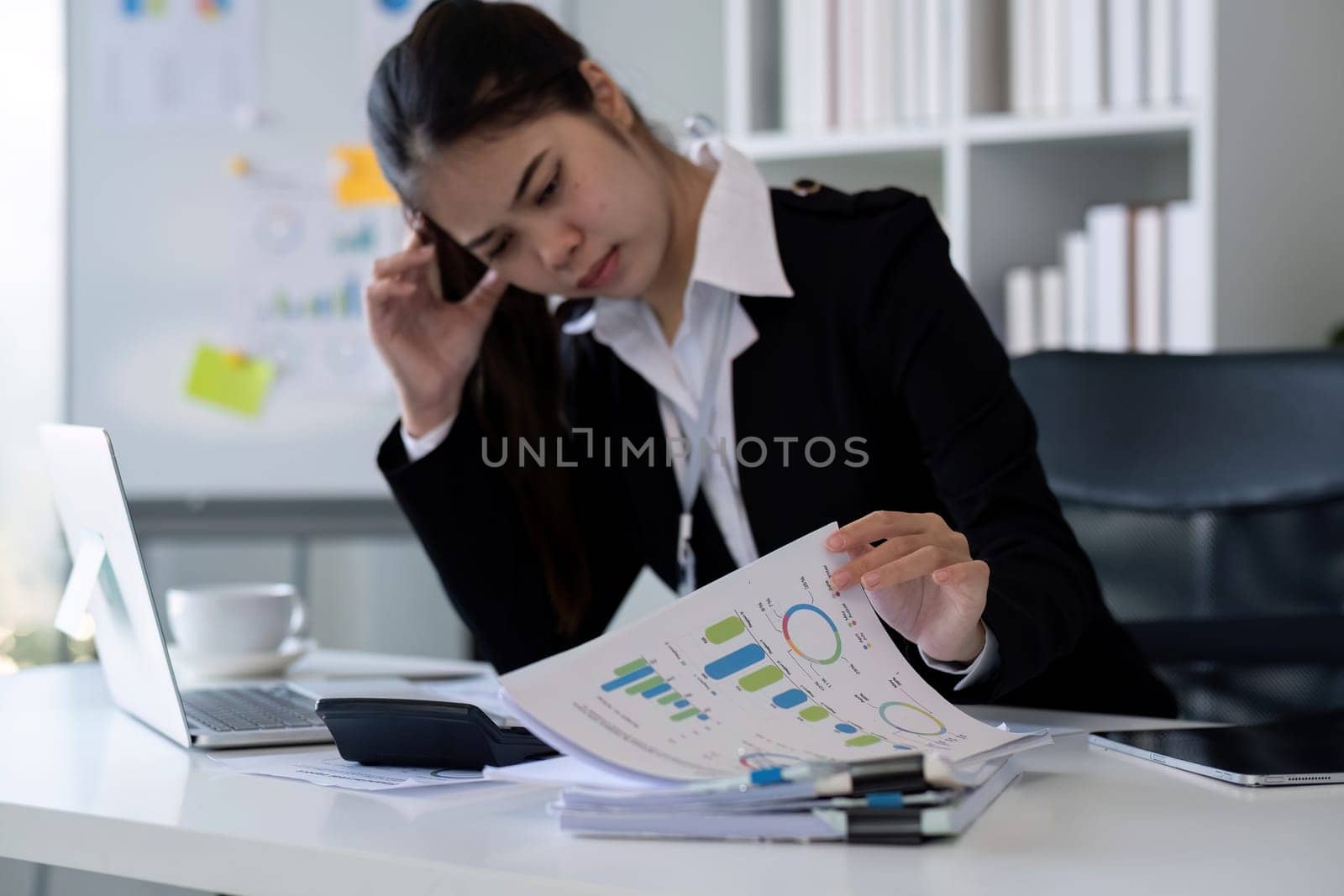 Business woman feeling tired from working in the office by wichayada