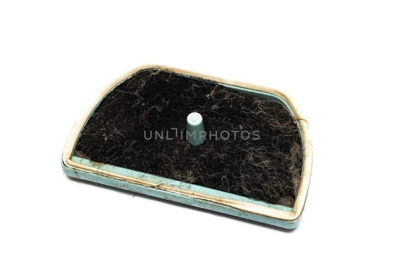 Old dirty filter for a vacuum cleaner isolated on white background