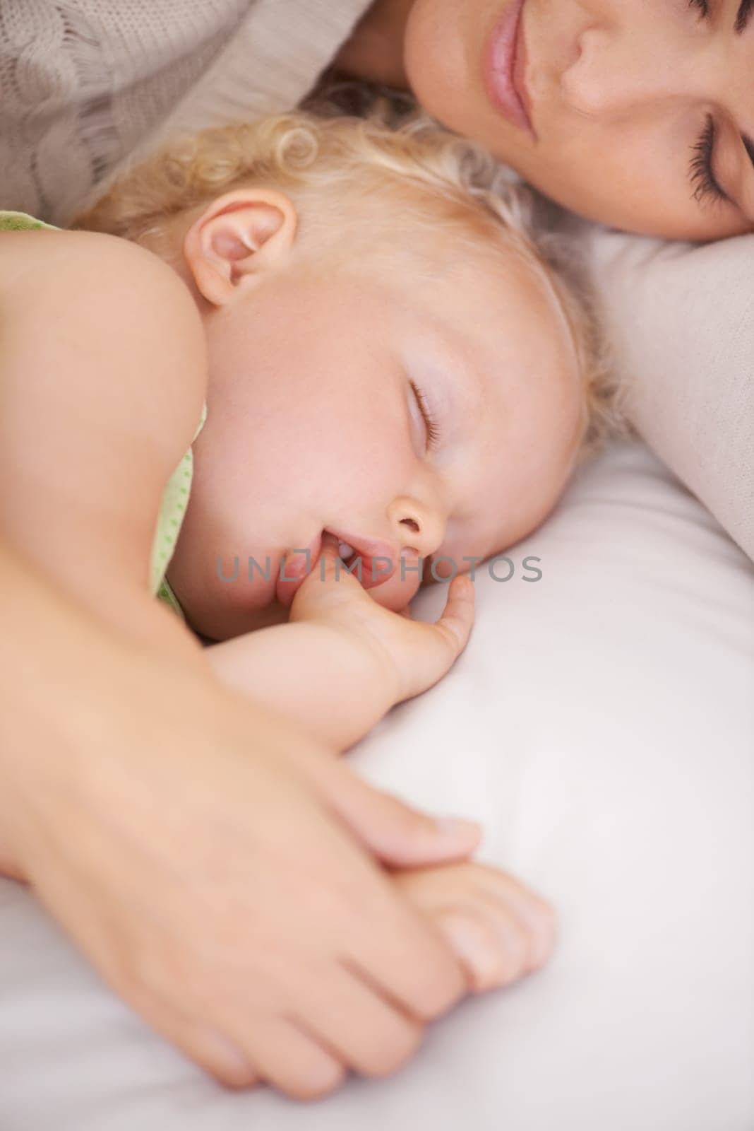 Mother, baby and kid suck thumb in home, adorable and cute innocent child with parent in house. Young blonde toddler, finger and mouth of healthy little girl sleeping in bedroom together with mama by YuriArcurs