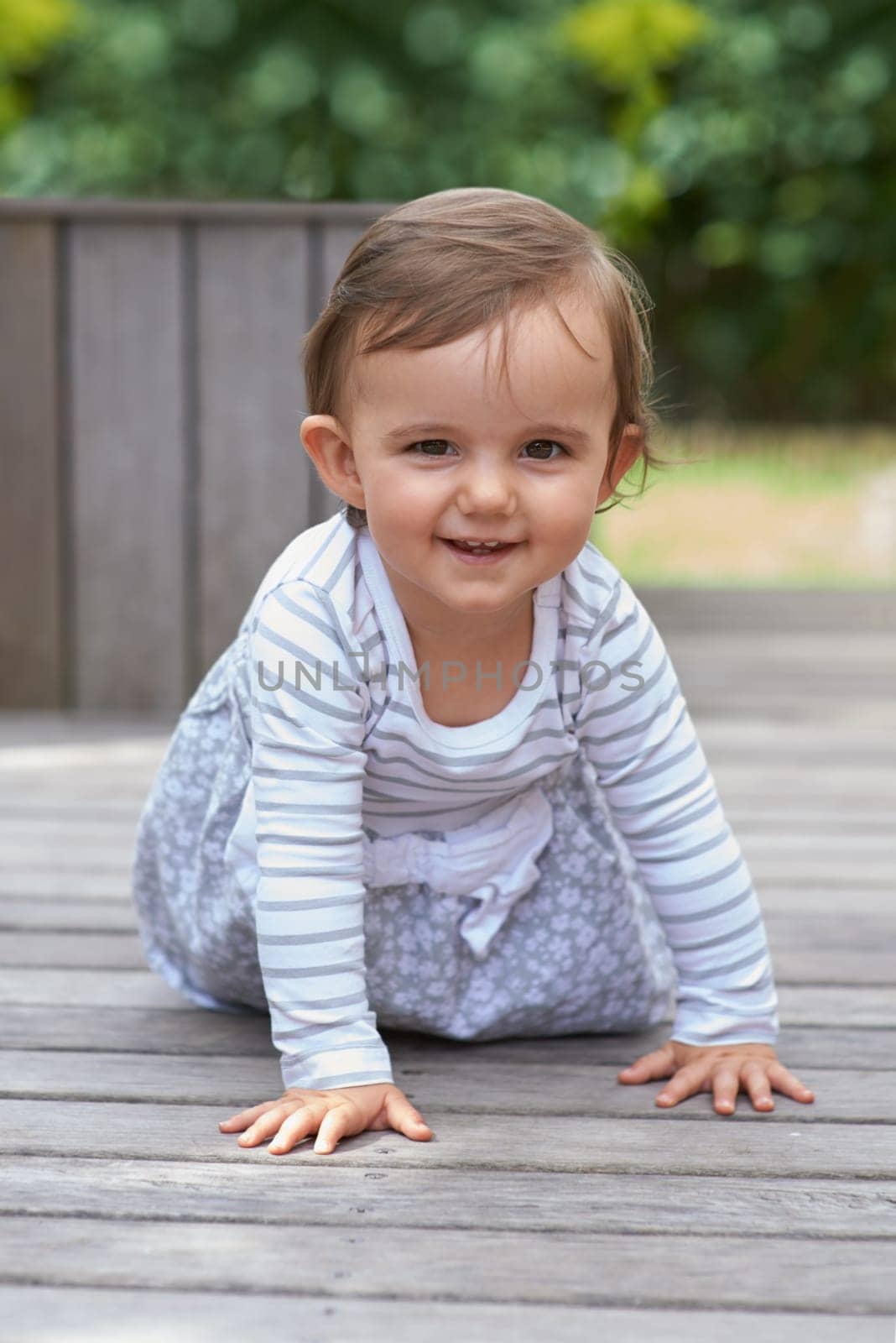 Baby girl, crawling outside and portrait on floor, child development and growth with sensory coordination. Girl, cognition and healthy in good mood, childhood or balance with arms, kid or adorable.