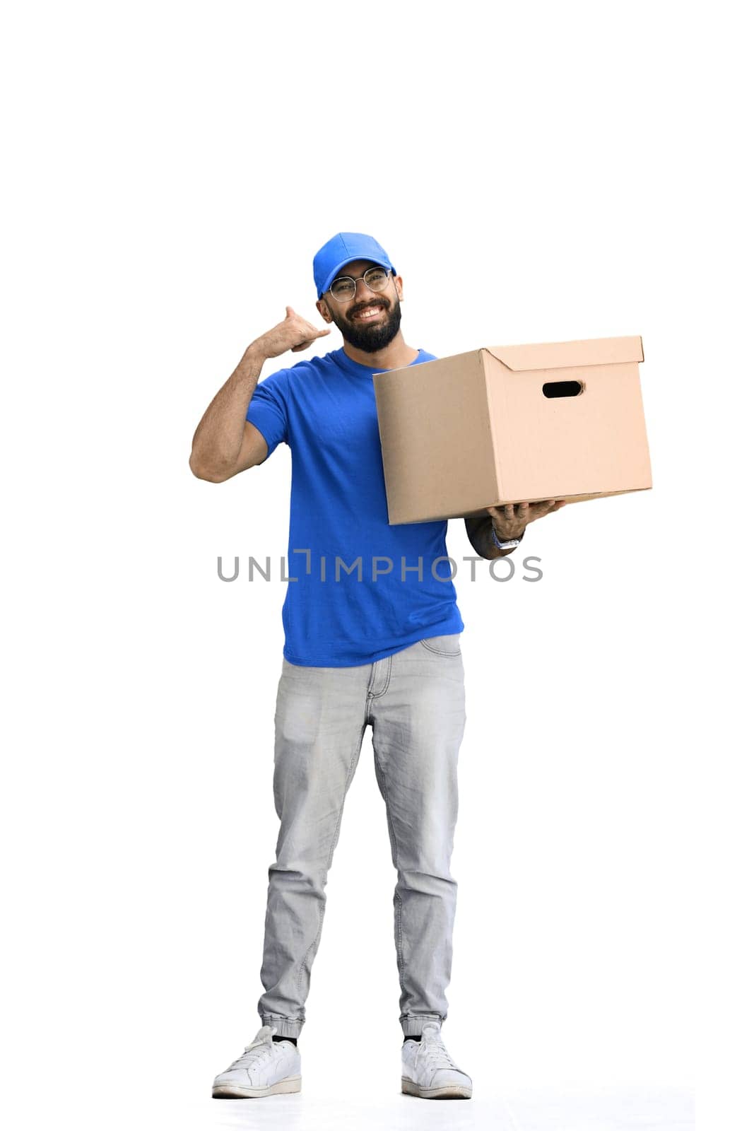 A male deliveryman, on a white background, in full height, with a box, shows a call sign by Prosto