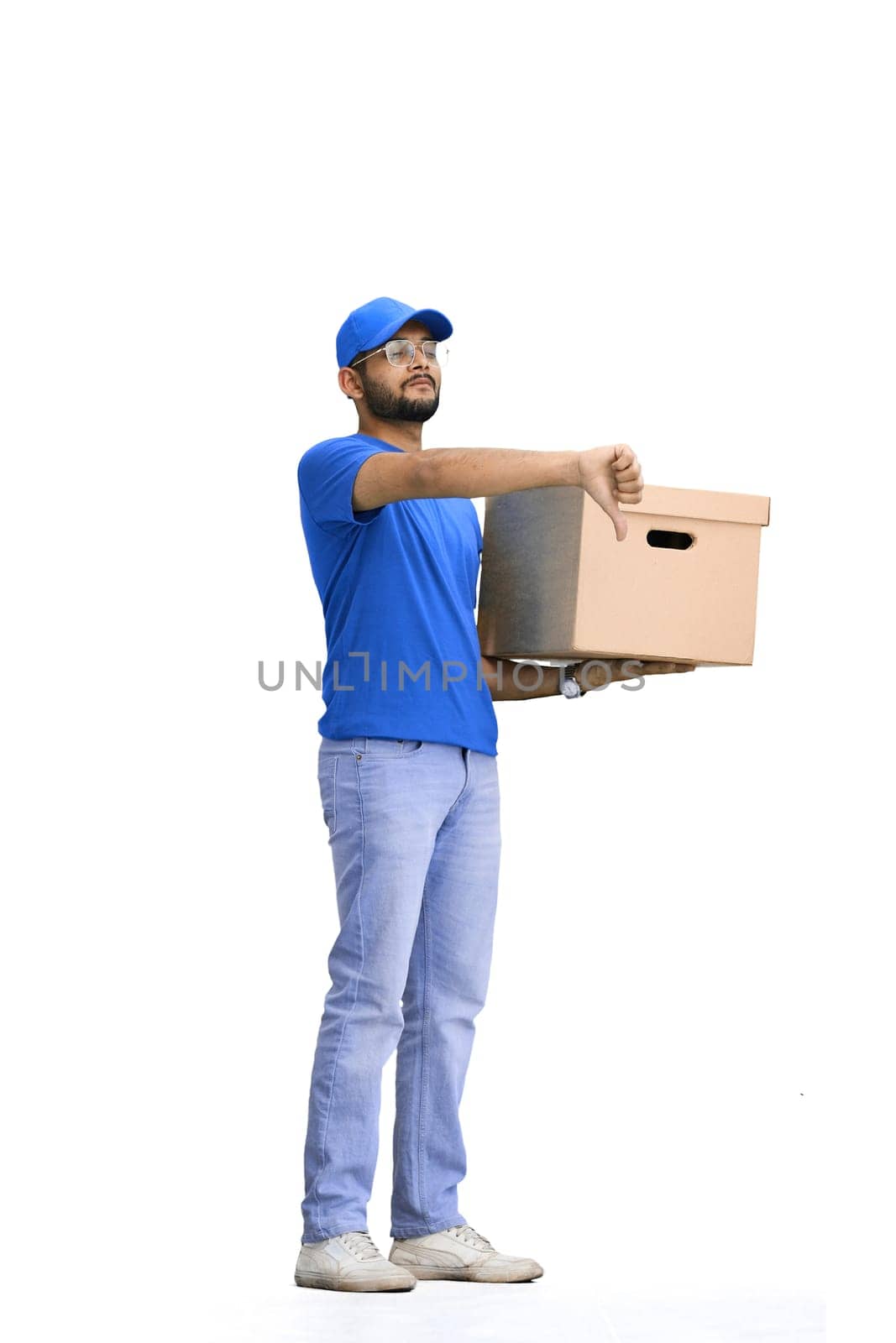A male deliveryman, on a white background, full-length, with a box, shows his finger down.
