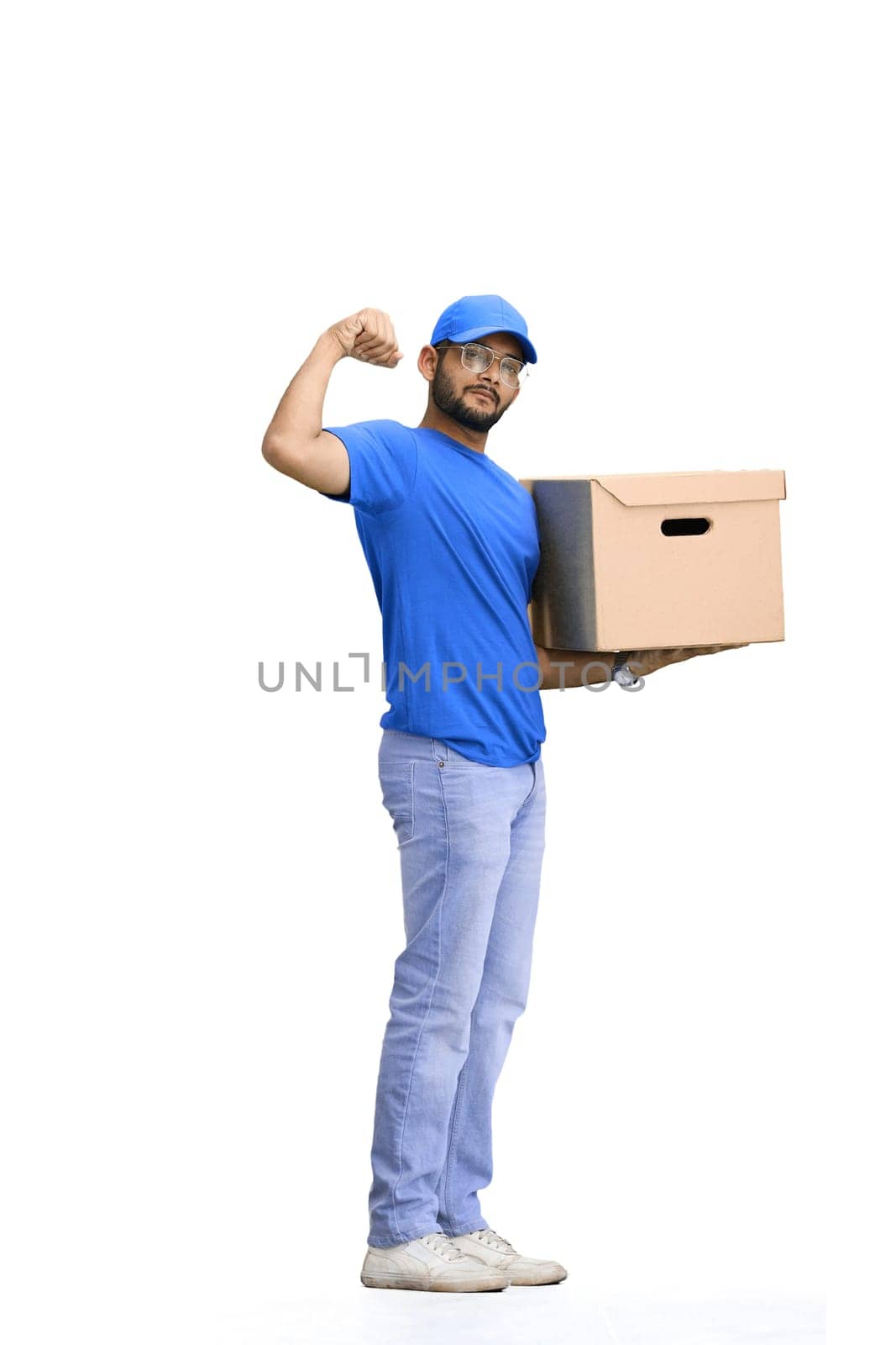 A male deliveryman, on a white background, in full height, with a box, shows strength by Prosto
