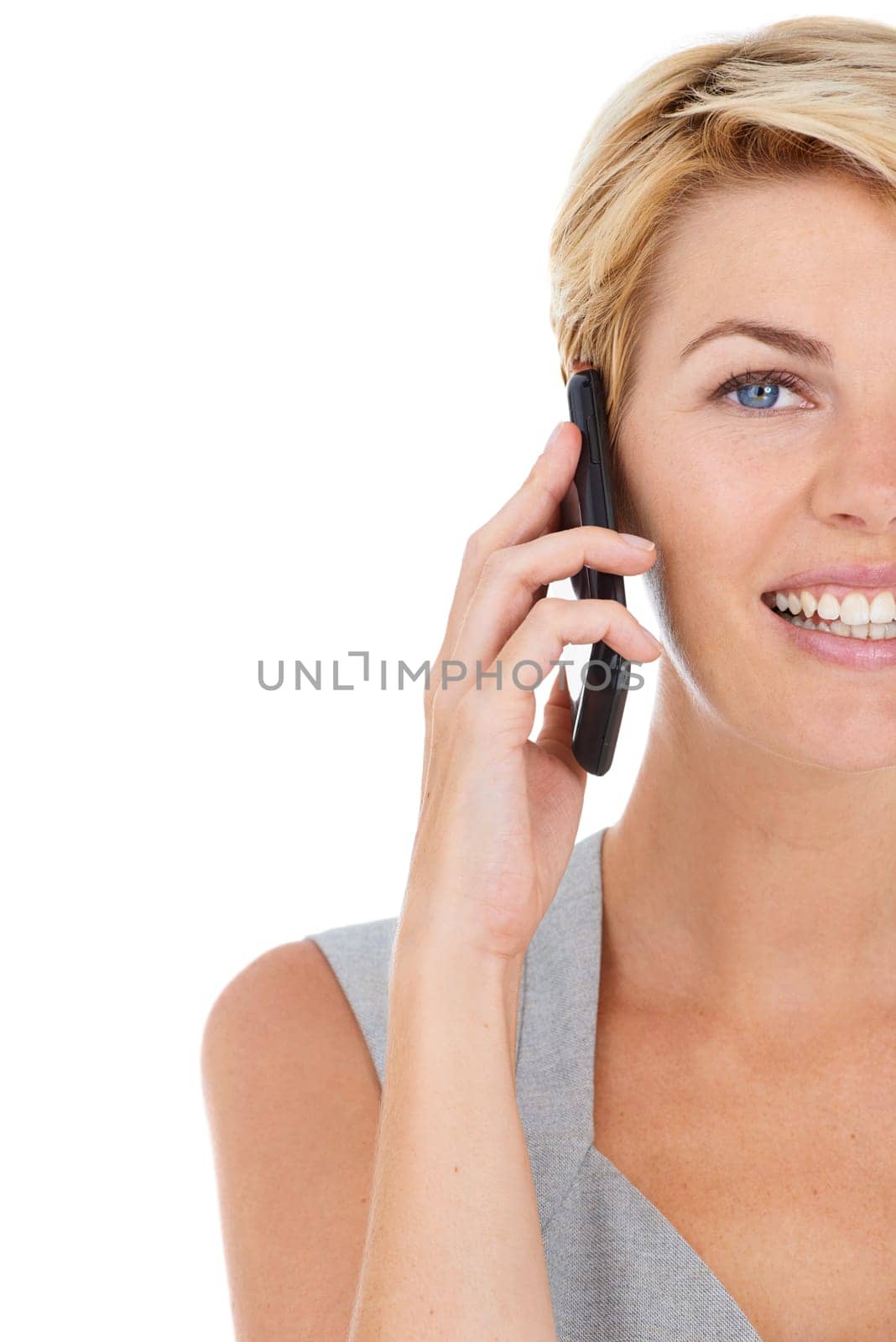 Businesswoman, phone call and conversation in studio portrait, communication and smile by white background. Happy female person, half face and smartphone for networking, discussion and technology by YuriArcurs