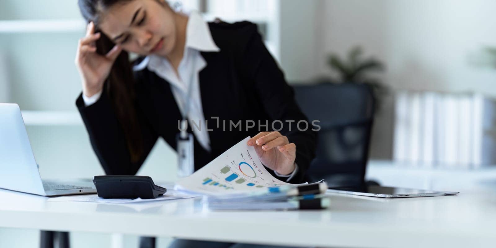Accountant woman working with calculator and calculate tax and stress about finance.