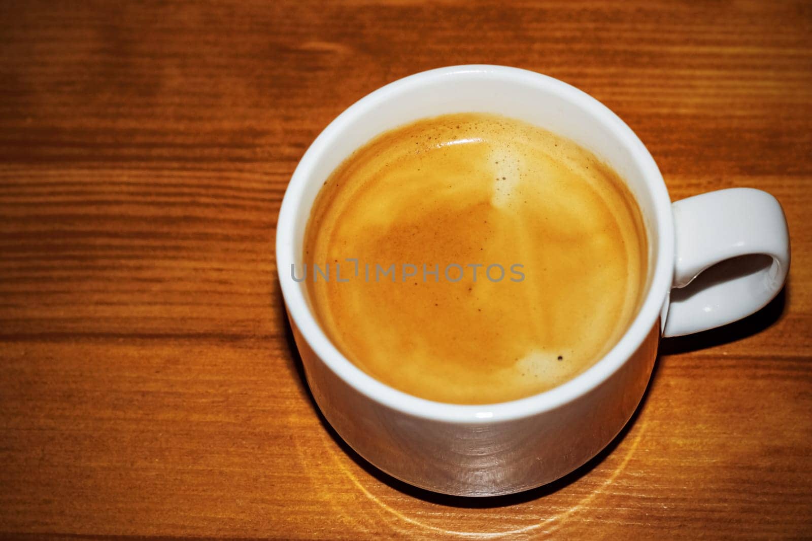 Cup of coffee on a wooden table with copy space