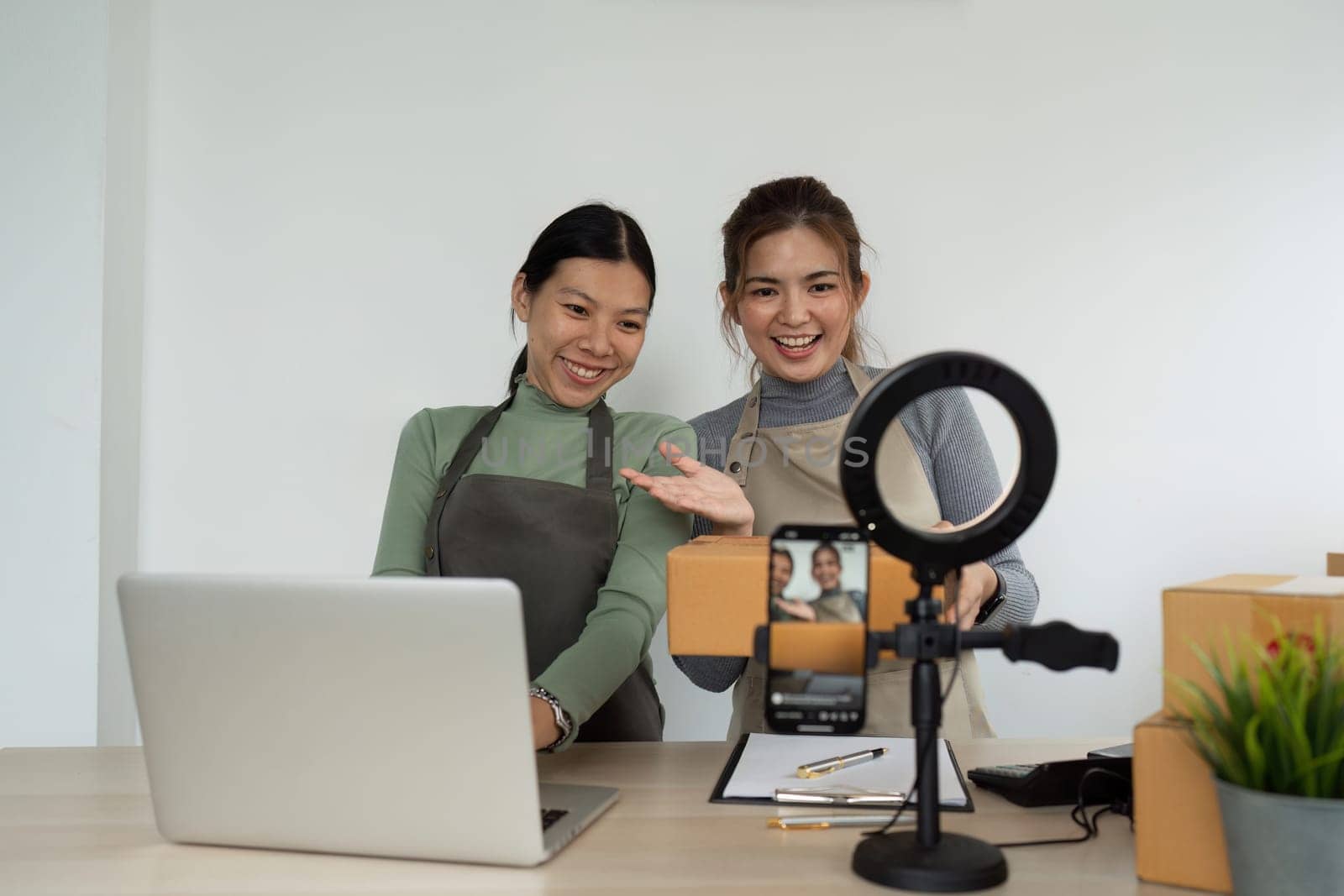 Beautiful asian woman showing clothes for sale in front of camera for live streaming at home by itchaznong