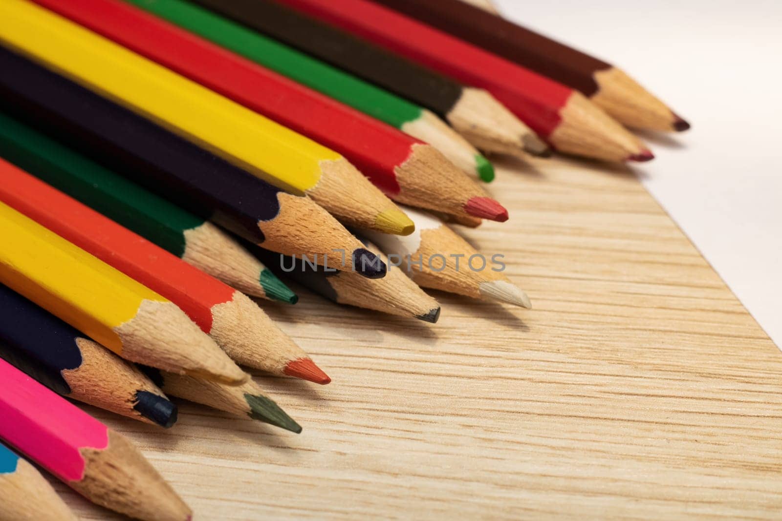 Colored pencils on a sheet of paper close up, macro photo