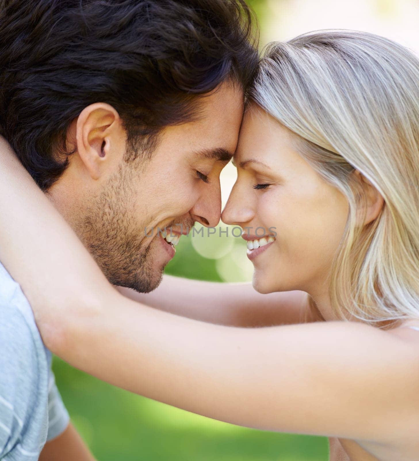 Forehead, love or happy couple in park for date, support or care on a summer in nature together. Relax, romantic man or woman with smile on outdoor holiday vacation for bond, travel or anniversary.