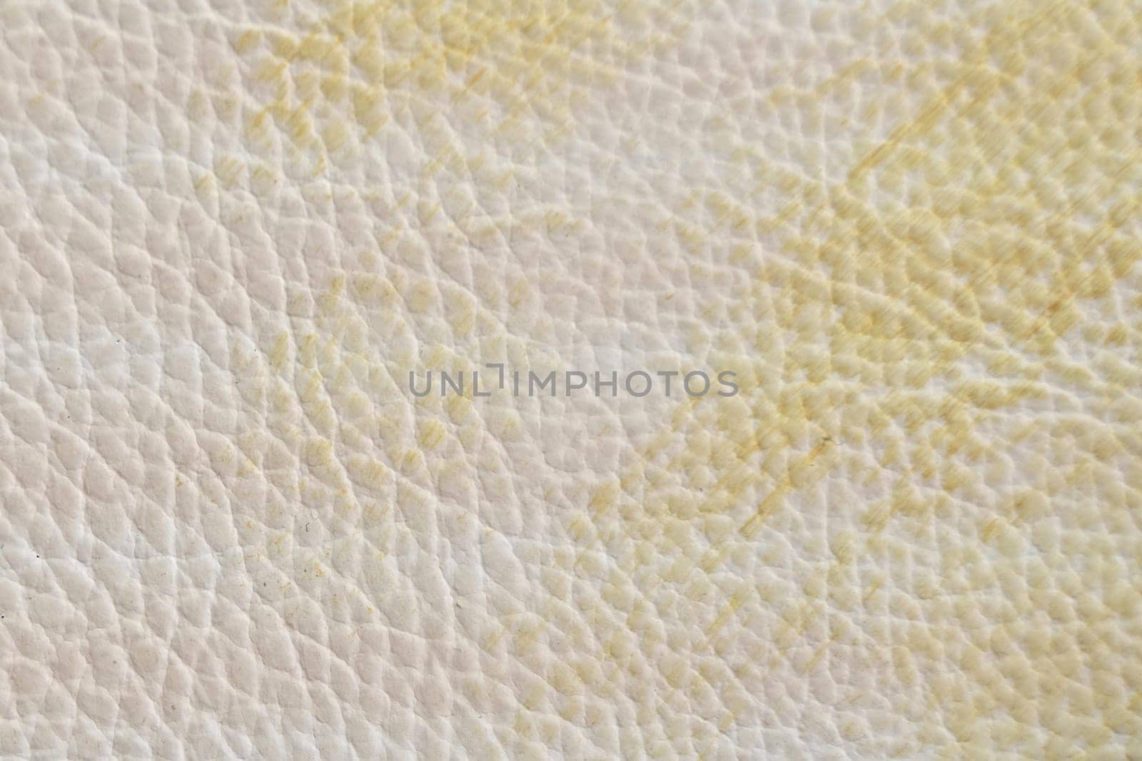 White and yellow leather texture with folds, used as a classic background. Texture and backgrounds