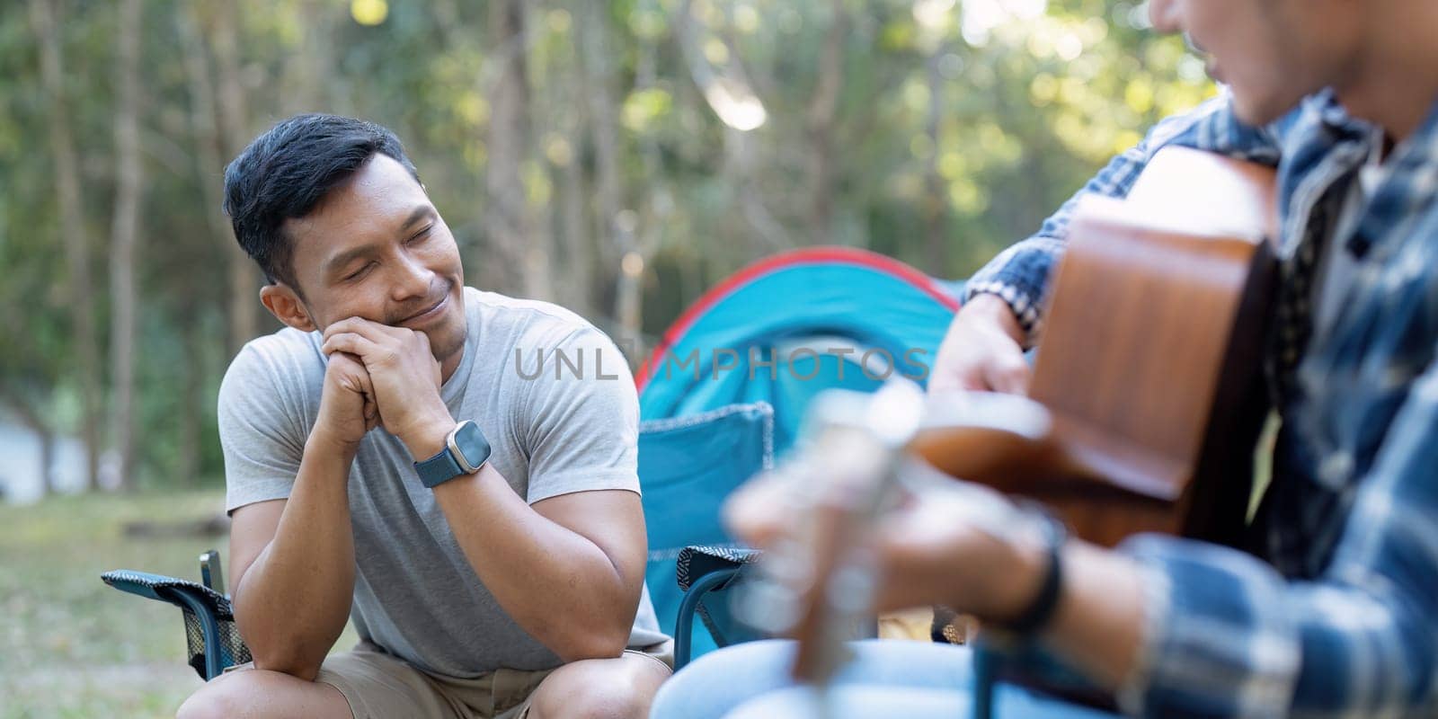 Happy Asian male gay couple on camping together in a forest. romantic vocation trip. lgbt concept.