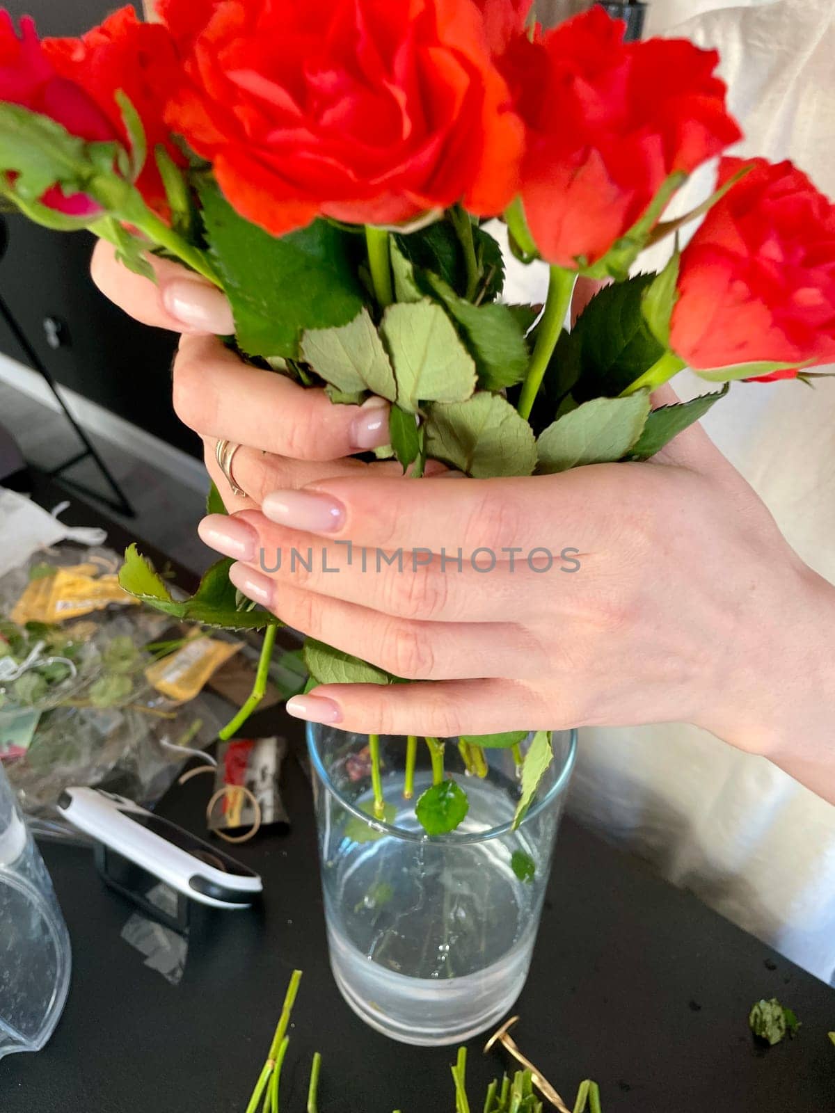 Female hands make a bouquet of red and white small roses. High quality photo