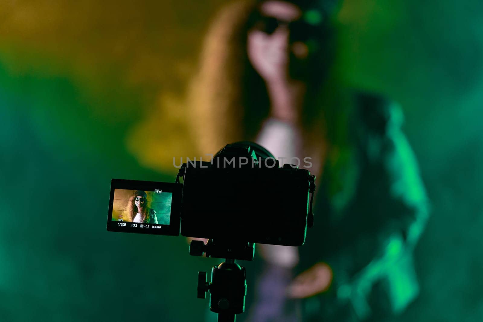 Backstage operator working professional camera. Videographer shoots music clip by kristina_kokhanova