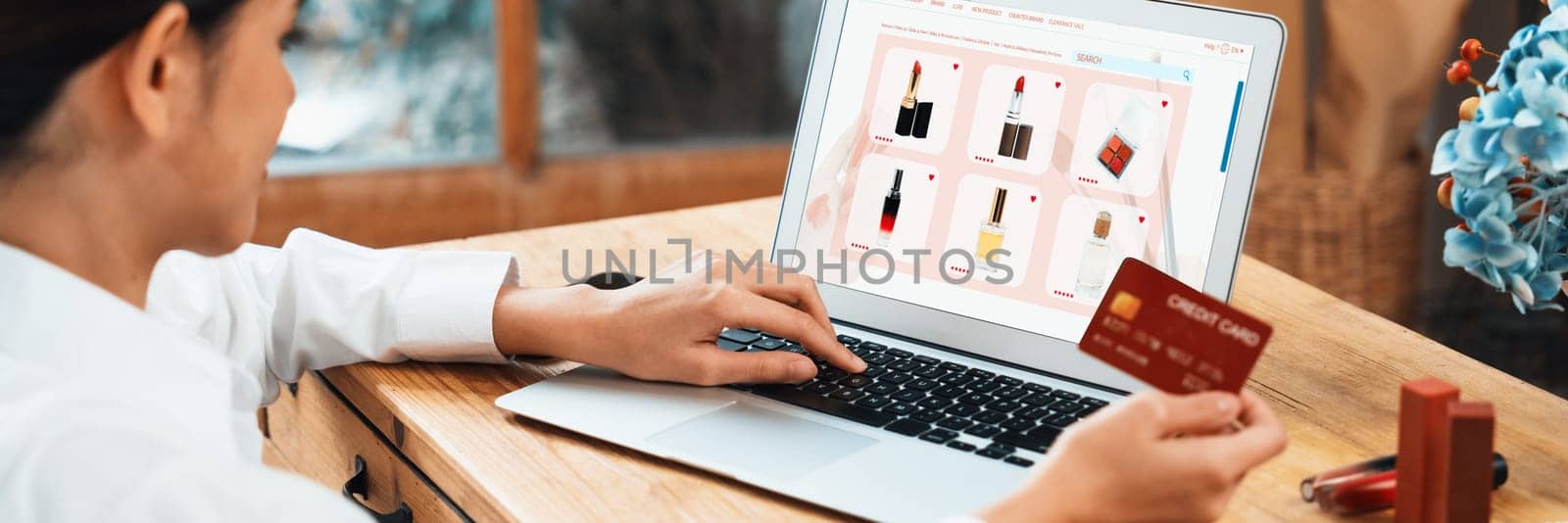 Woman shopping online on internet marketplace browsing for sale items for modern lifestyle and use credit card for online payment from wallet protected by uttermost cyber security software