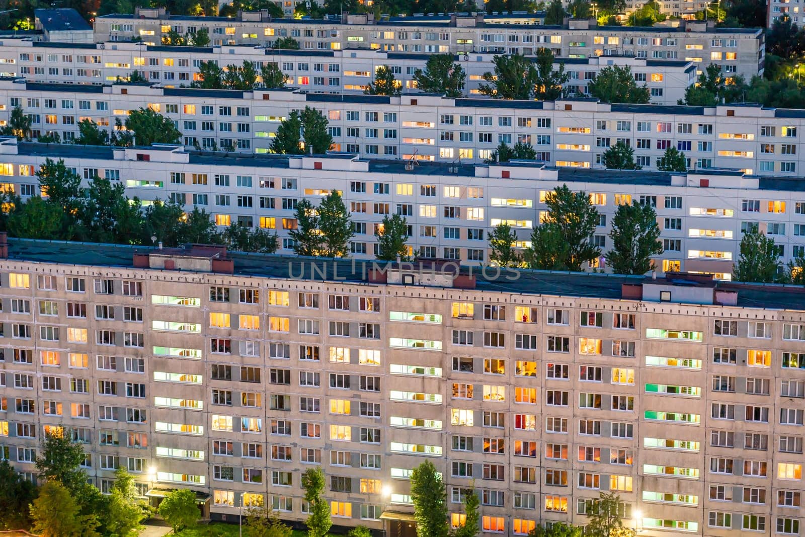 Timelapse of residential quarters of the night city with the lights on from the windows of the apartments. by DovidPro