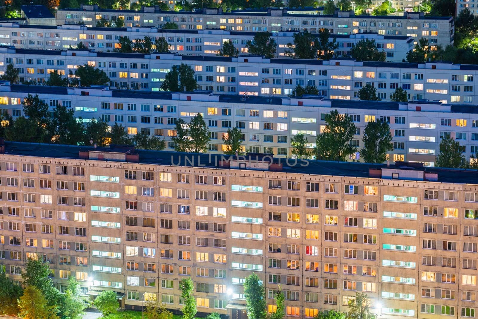 Timelapse of residential quarters of the night city with the lights on from the windows of the apartments