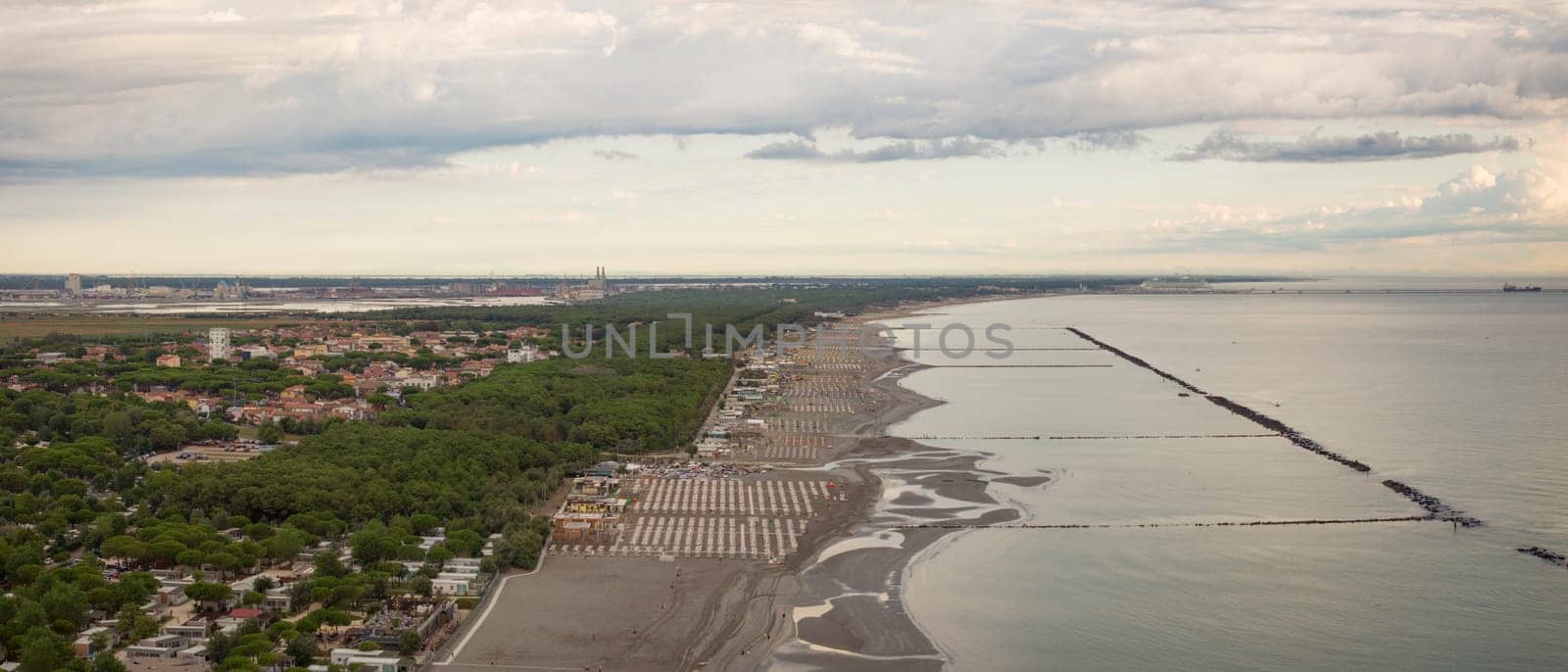 Drone view of sandy beach with umbrellas and gazebos.Summer vacation concept,Adriatic coast, Emilia Romagna,Italy.