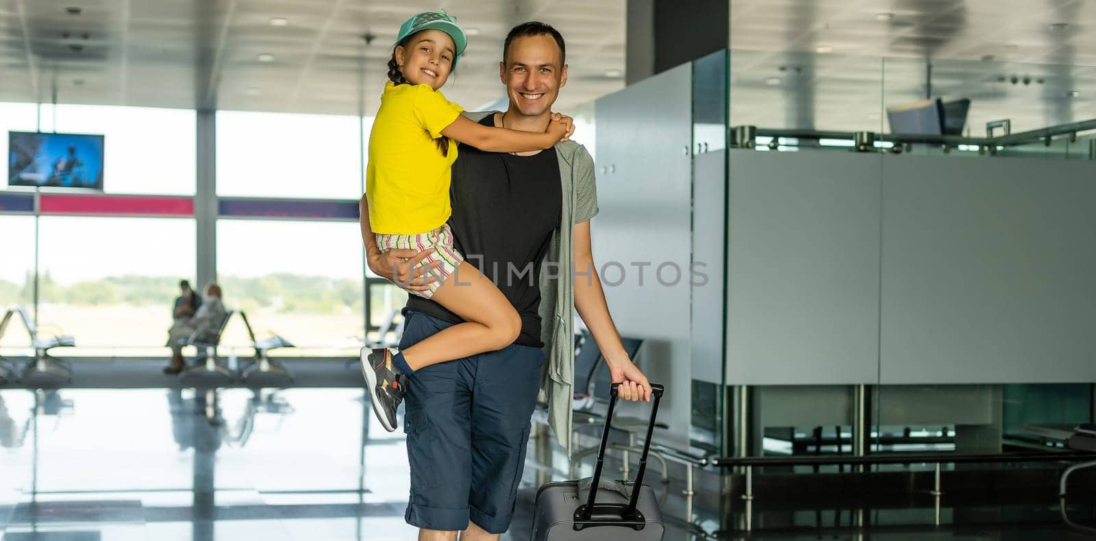 Young father with daughter at the airport.