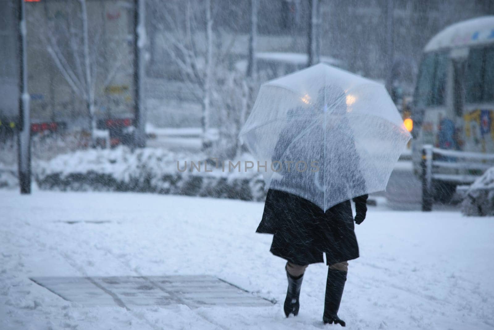 A man with an umbrella in the snow by jameshumble