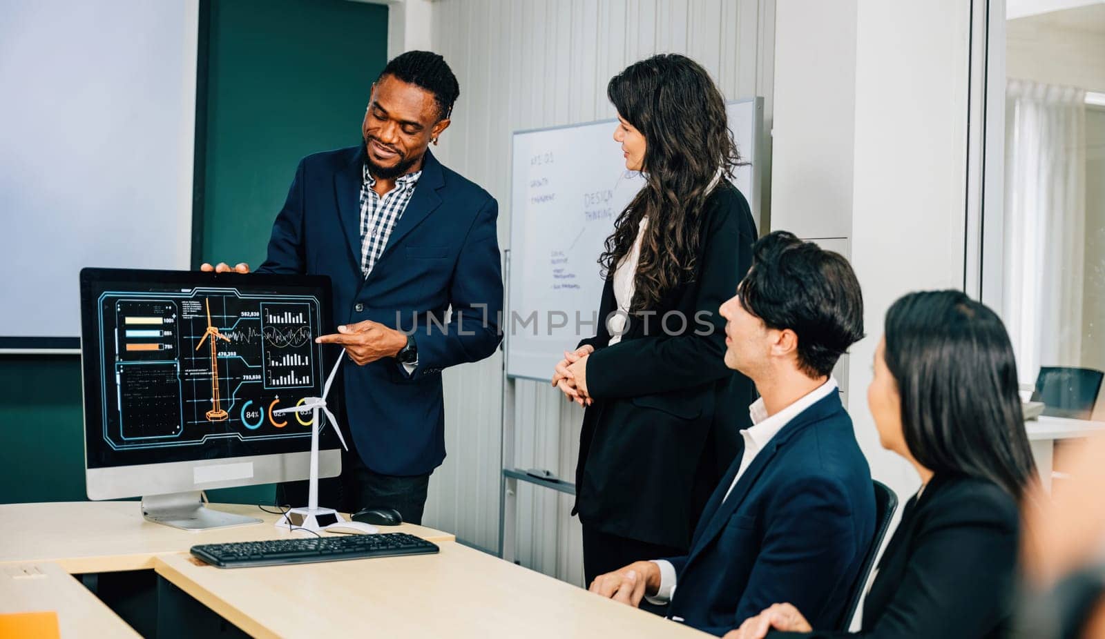 Colleagues with diverse skills and backgrounds convene at the office, discussing new investment strategies on a PC computer monitor. Their teamwork, discussion, and leadership foster marketing success by Sorapop