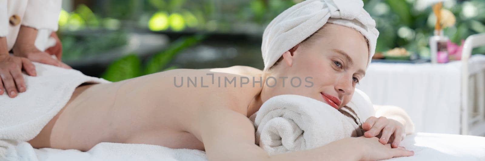 Beautiful relaxing woman having back massage surrounded by nature. Tranquility. by biancoblue