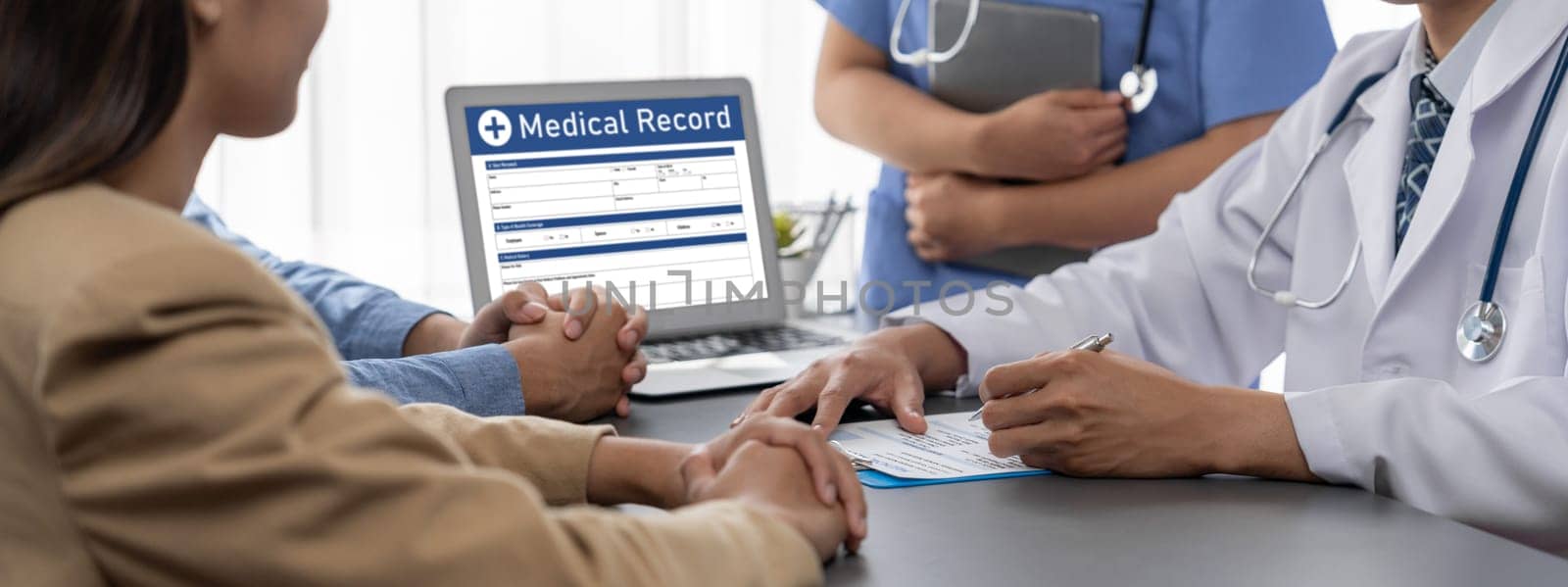 Doctor show medical diagnosis report on laptop to young couple. Neoteric by biancoblue