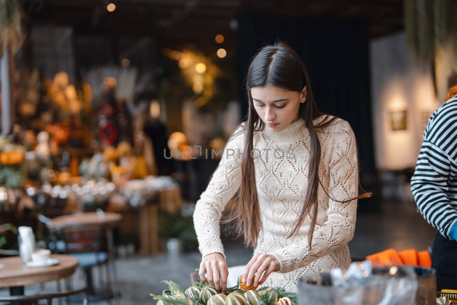The last steps in completing the Christmas wreath at the flower shop counter. High quality photo