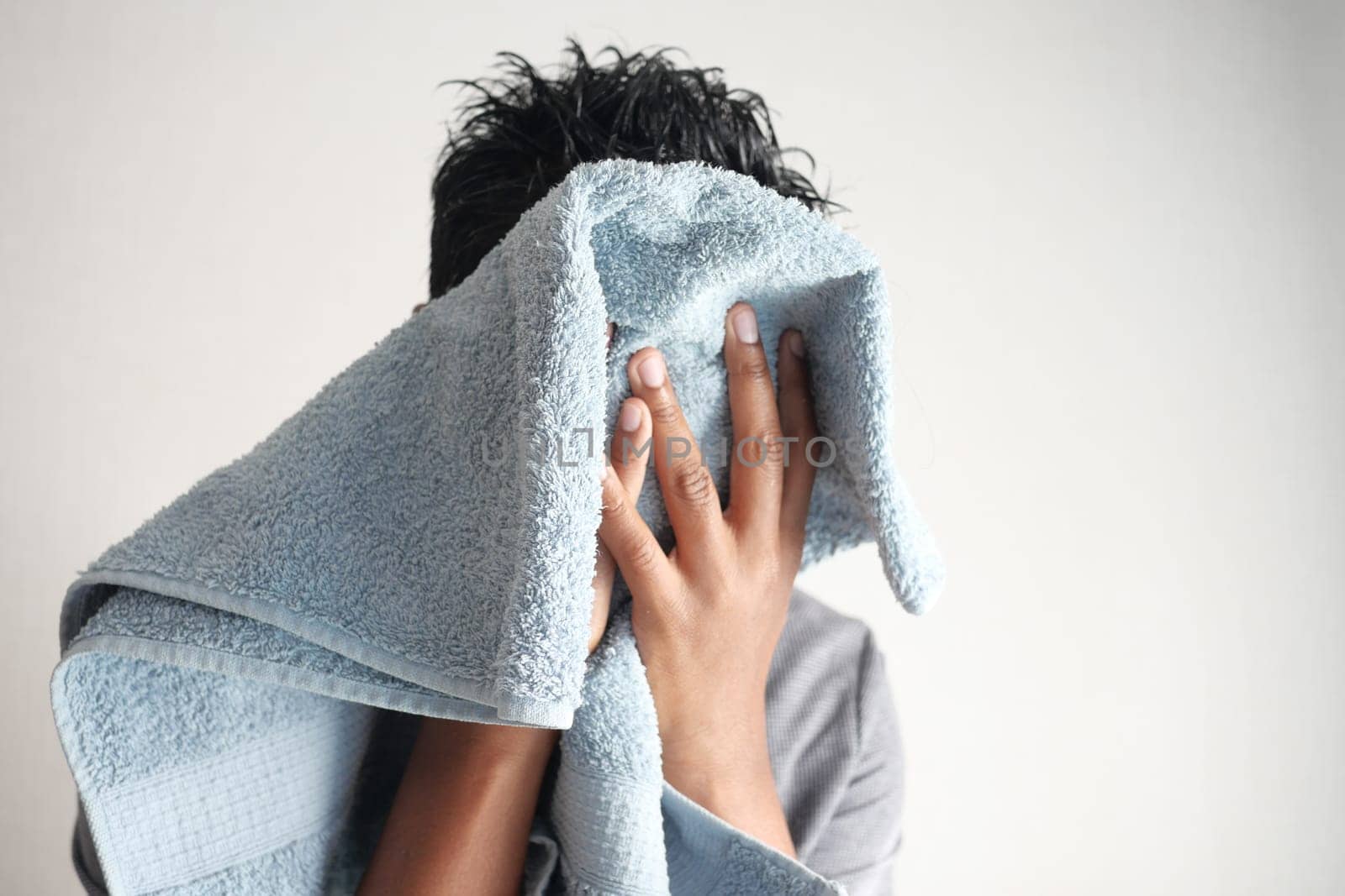 young Man drying his face