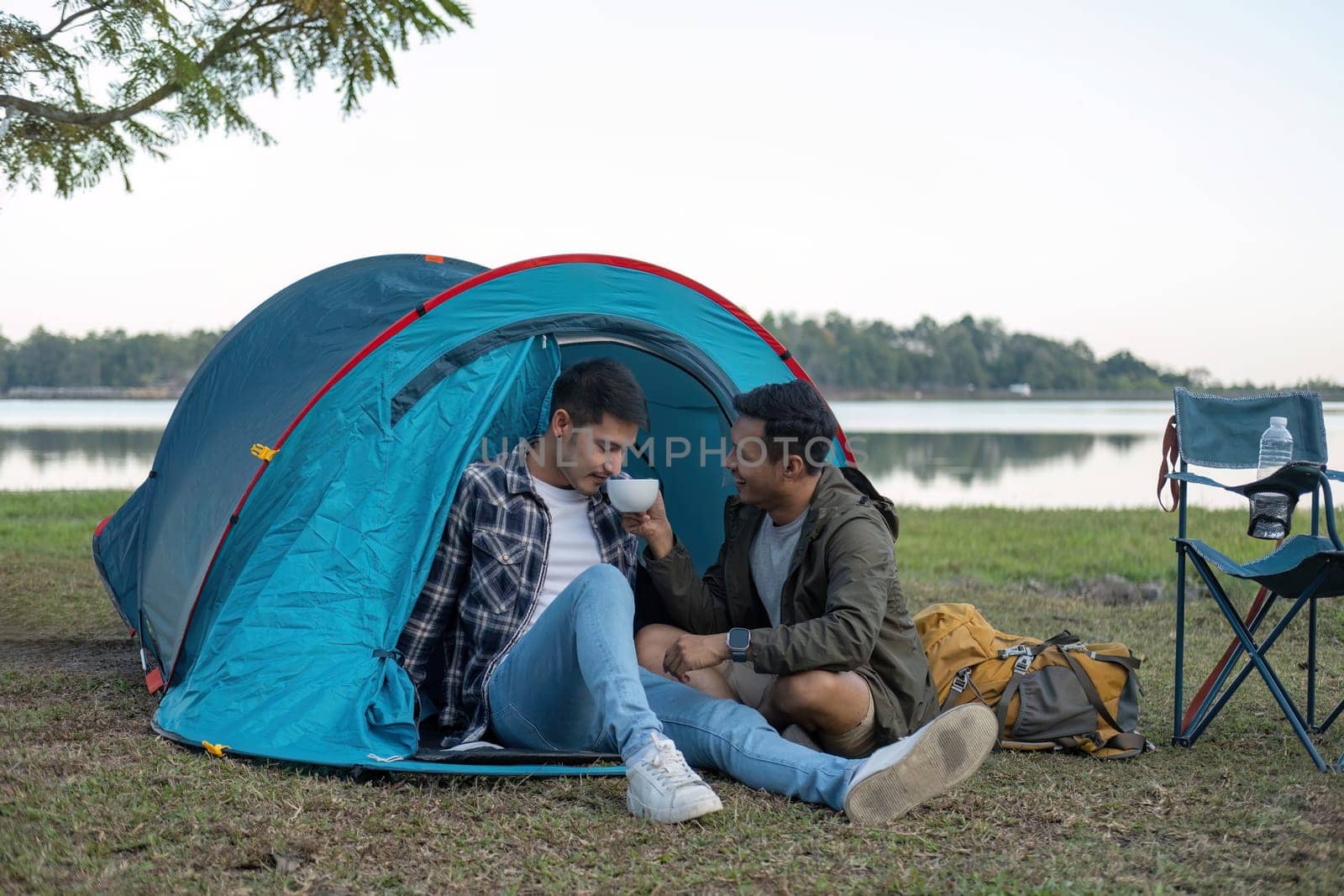 Happy Asian male gay couple on camping together in a forest. romantic vocation trip. lgbt concept.