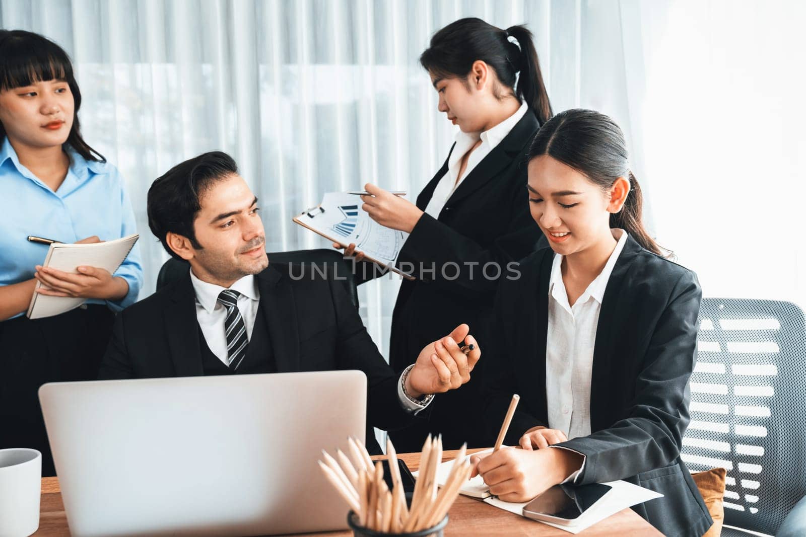 Diverse of business people from various ethnic group working in modern office environment. Productive and multi ethnic office workers engage in discussion for strategic business marketing. Meticulous