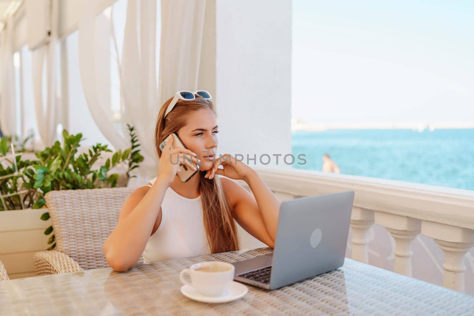 Woman coffee cafe macbook. Woman sitting at a coffee shop with mobile phone drinking coffee and looking away. Caucasian female relaxing at a cafe. by Matiunina