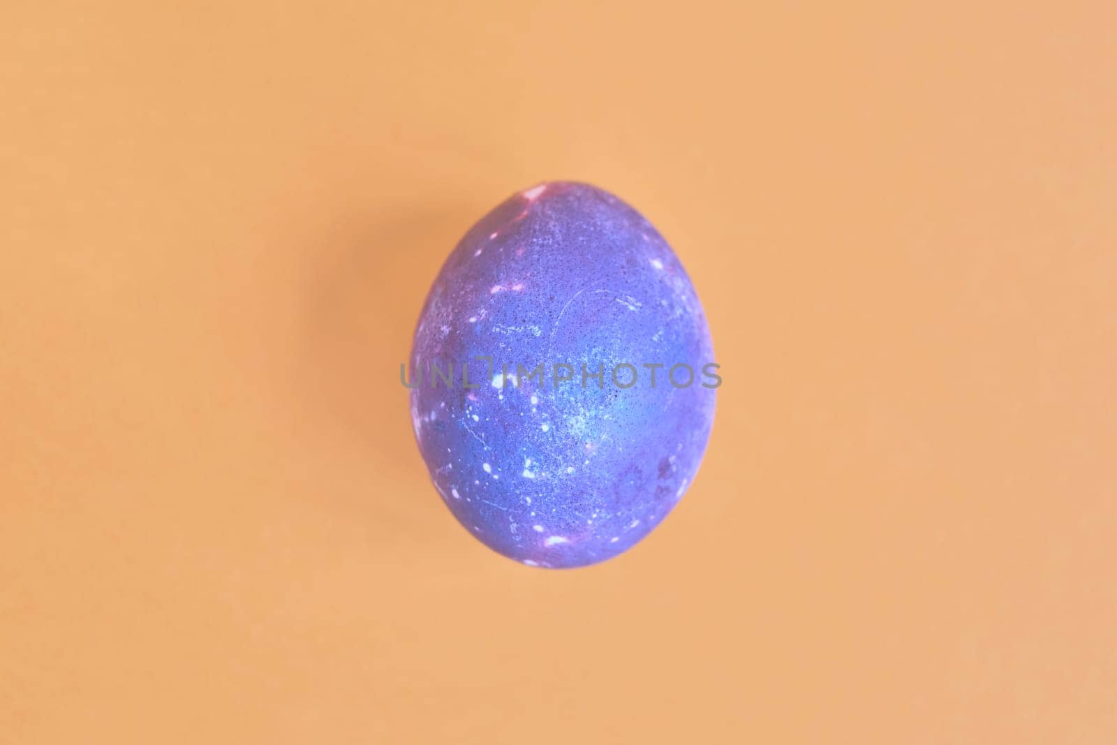 Cosmic galactic Easter egg on yellow pastel background