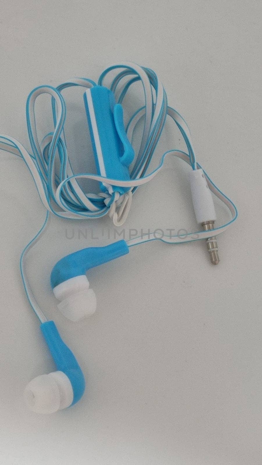 headphones with wire, background object,blue and white, inexpensive. High quality photo