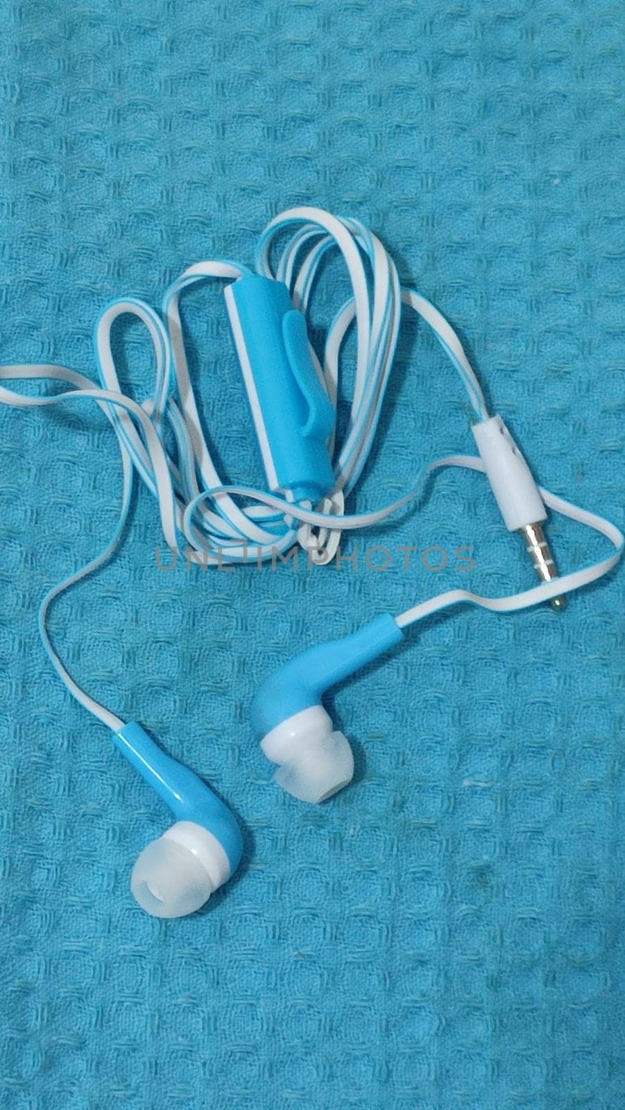 headphones with wire, background object,blue and white, inexpensive. High quality photo