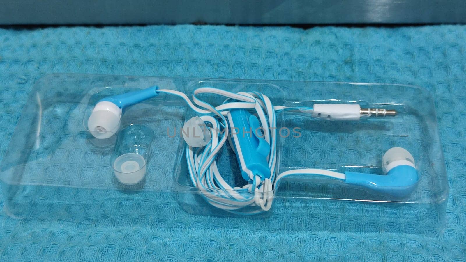 headphones with wire, background object,blue and white, inexpensive. High quality photo