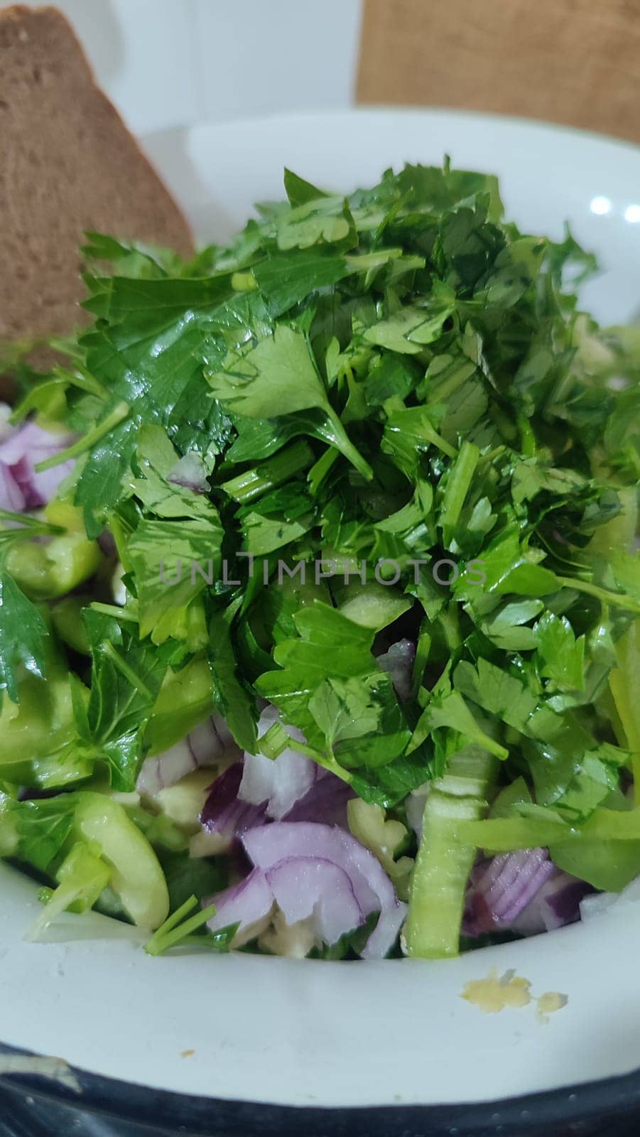 fresh green parsley salad, red onion, cheese, kitchen board, food, vegetarianism. High quality photo