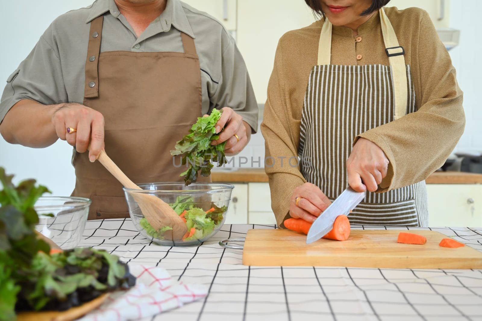 Cropped shot of senior couple preparing a healthy vegetable salad at home