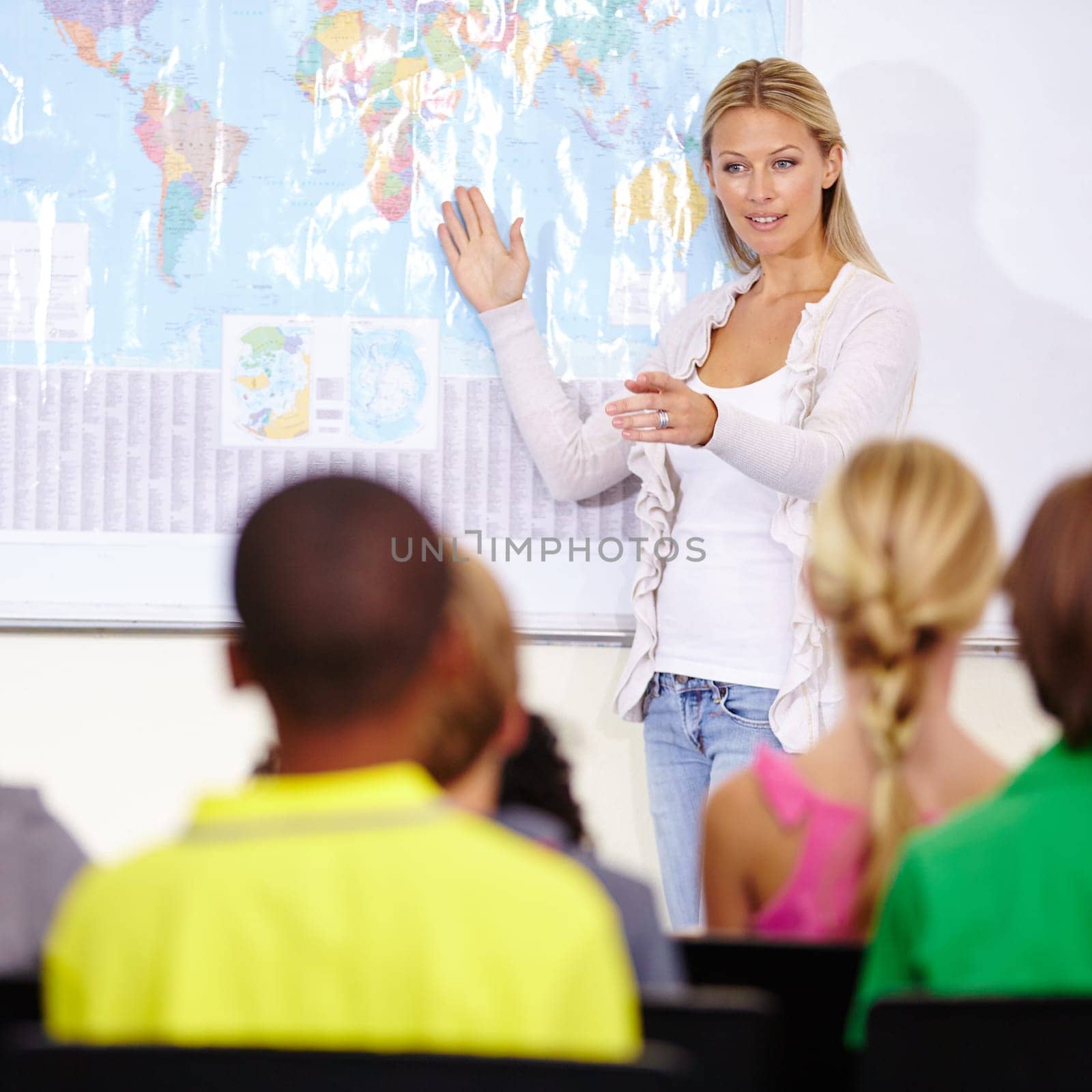 Teacher woman, geography and map for education with pointing, lecture and question for children. Person, teaching and talking to school kids in classroom, learning or development with quiz at academy.