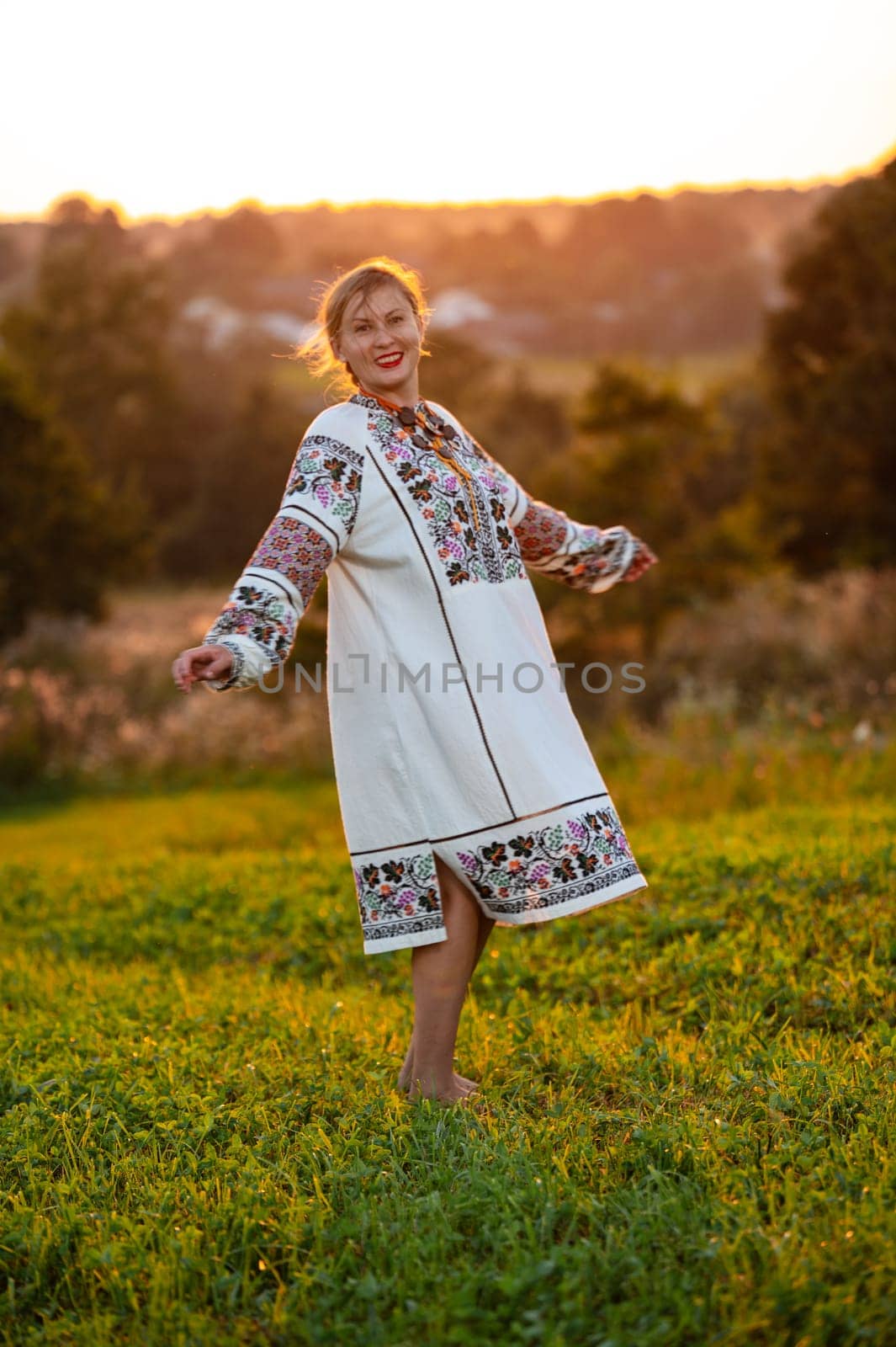 Embroidered and unique petticoat, a girl walks barefoot in the field in an embroidered shirt. by Niko_Cingaryuk
