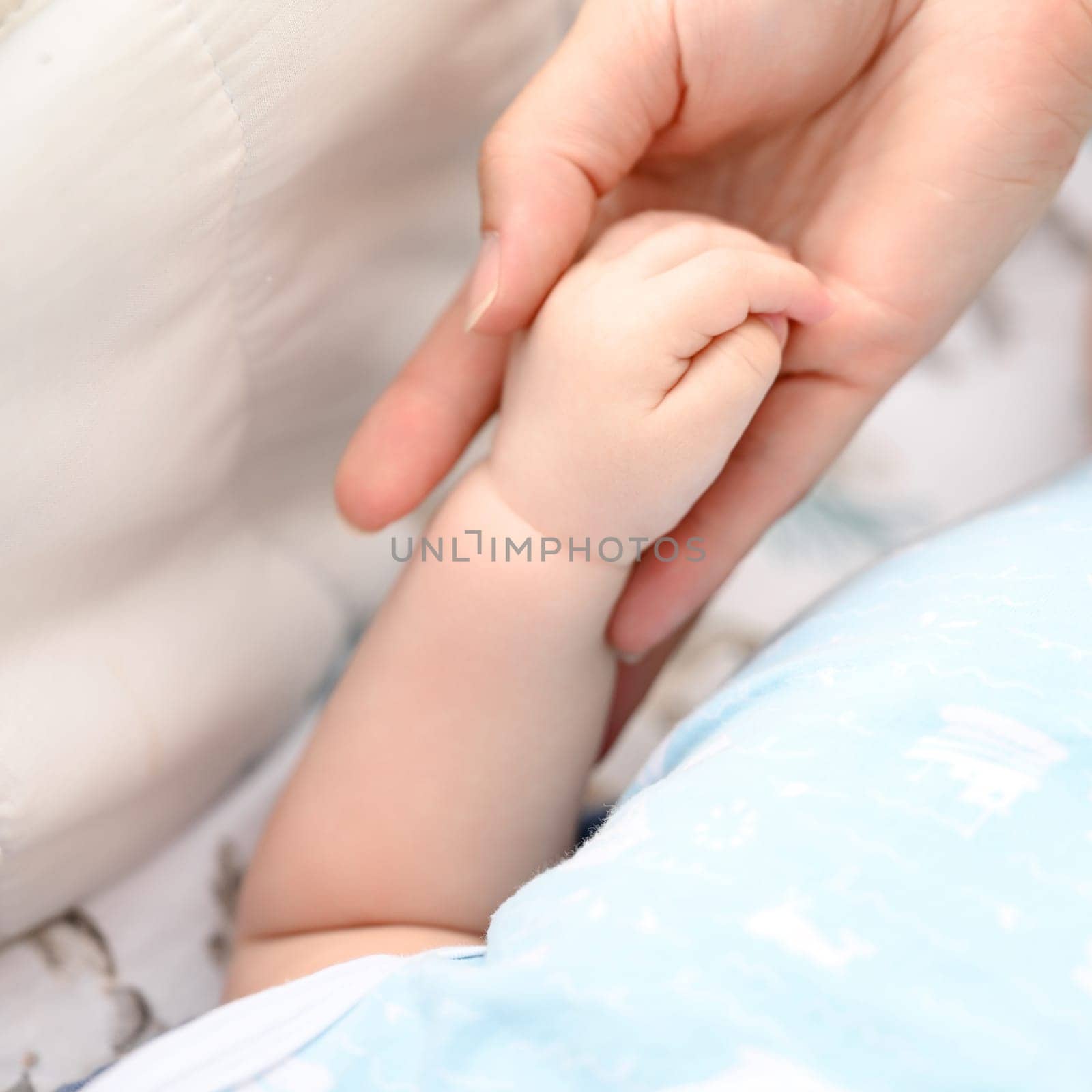 Close-up of a newborn baby's small hand. by Niko_Cingaryuk