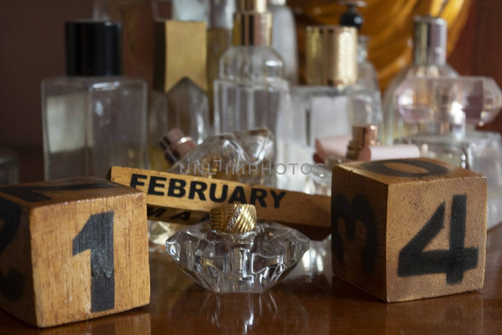 Valentine's Day represented through wooden cubes among perfume bottles