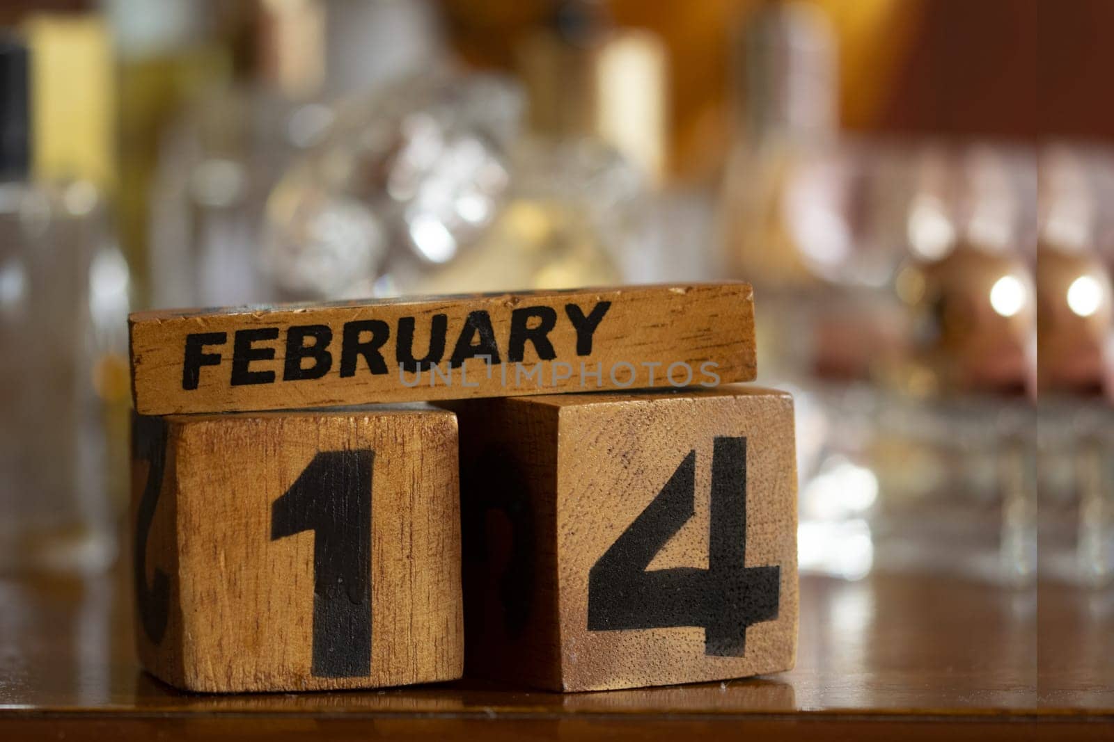 Valentine's Day represented through wooden cubes among perfume bottles